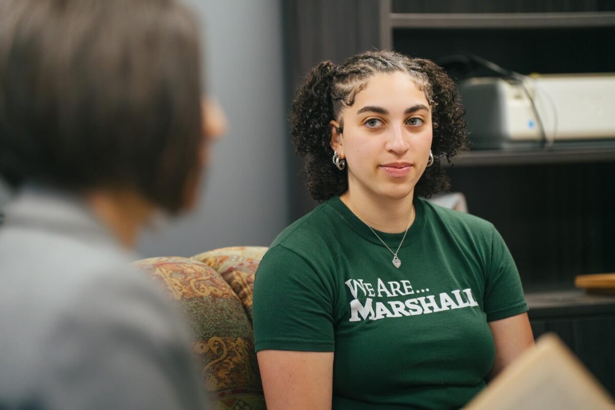 stiudent listening intently to professor during class