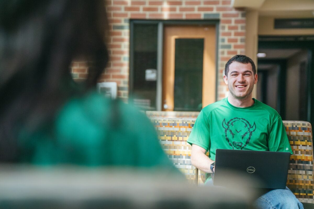 student working on a laptop in the engineering building