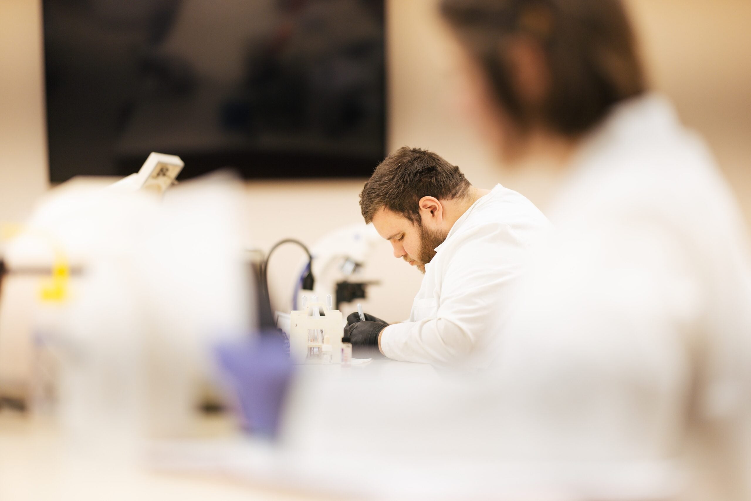 student working on a lab sample
