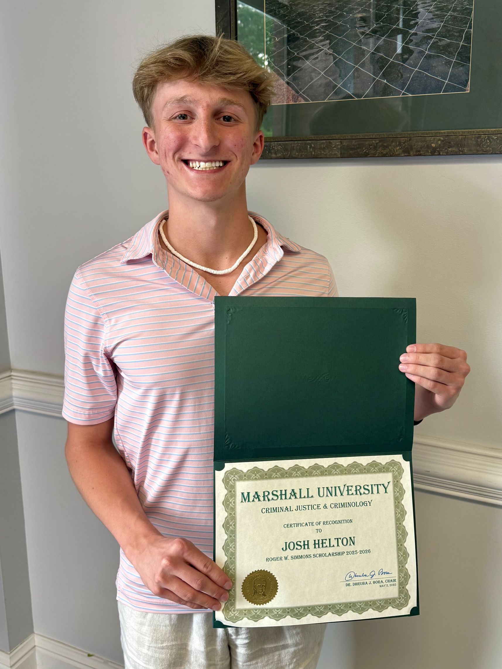 Josh Helton with a certificate