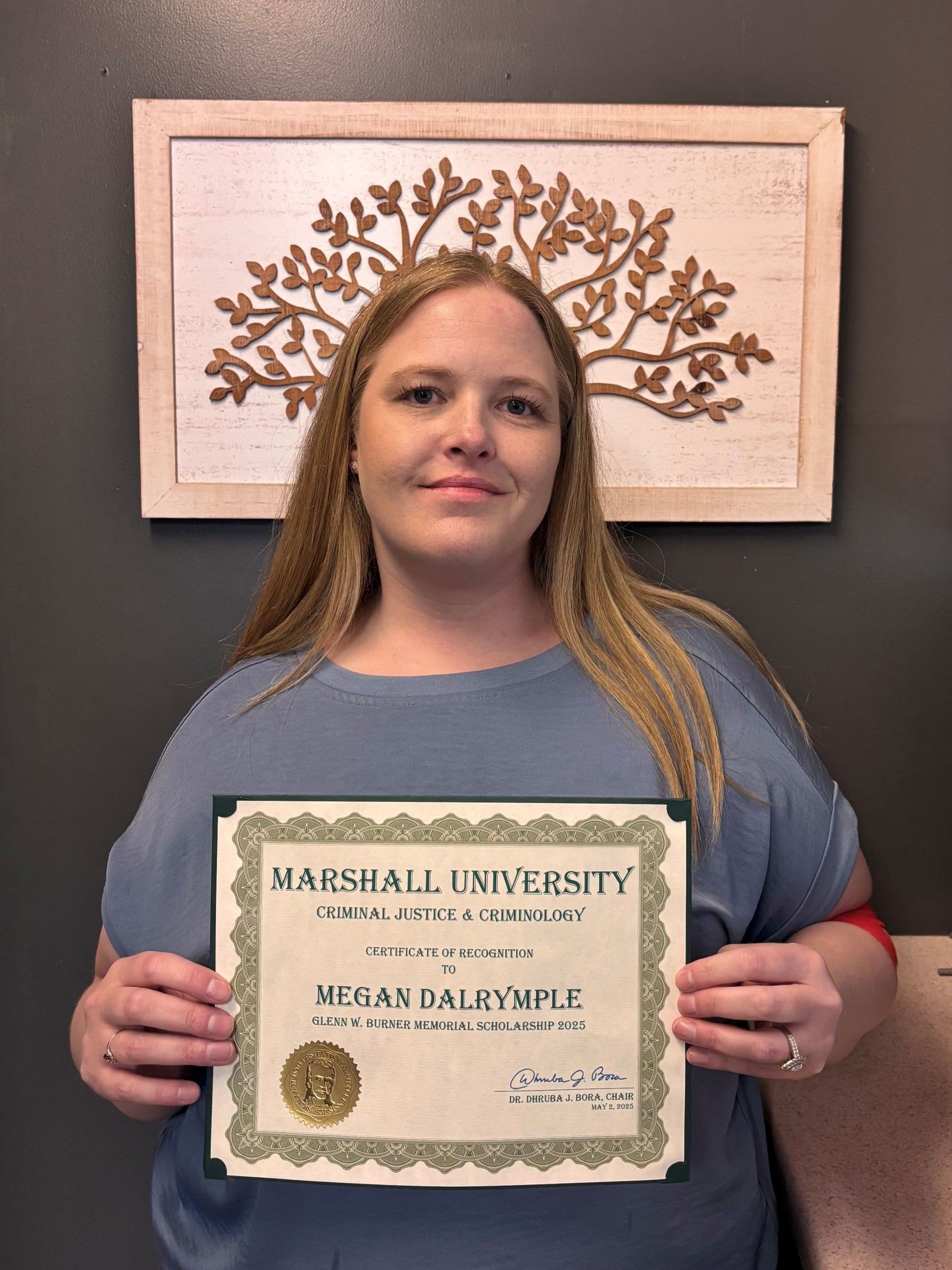 Megan Dalrymple with a certificate