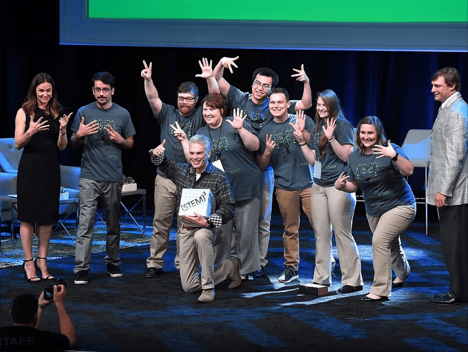 students posing and smiling at a camera after winning a competiton