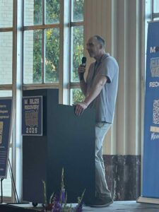 Jeremy Bailey speaks at a podium during a Campus Surge event.