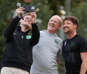 Erik Cochrane takes a selfie with professor Dan Hollis and Alumni Director, Matt James during the 2025 Marshall University Homecoming Parade
