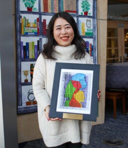 Dr. Huanshu Yuan receiving her award