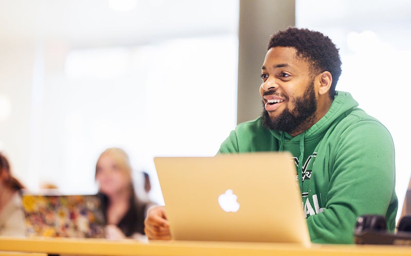 Student with a laptop in a class at Marshall University