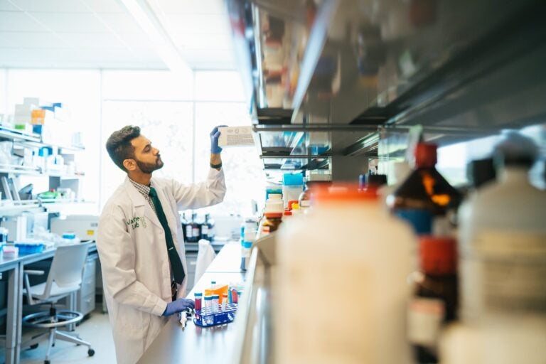 Monis Ali working in a lab as a pharmacy student