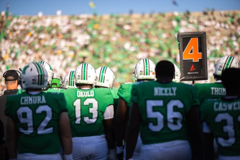 football players from the sidelines looking at the crowd