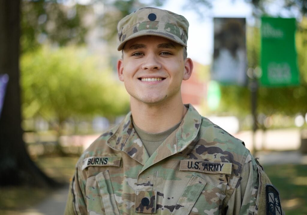 student on campus in an Army uniform