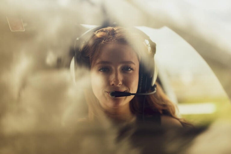 Female student in cockpit of plane