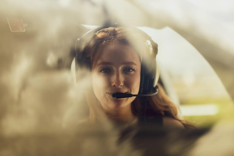 Female student in cockpit of plane